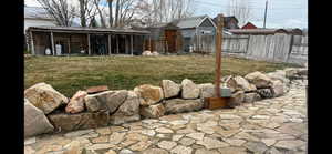Fenced backyard with an outbuilding