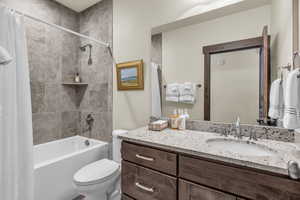 Full bathroom featuring shower / tub combo with curtain and vanity