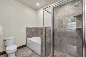 Full bath with a garden tub, a shower stall, and recessed lighting