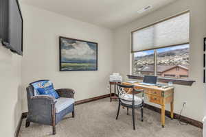 Home office with carpet and baseboards