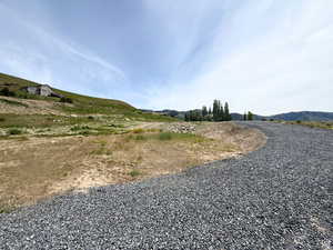 View of dirt / gravel road with a mountain view