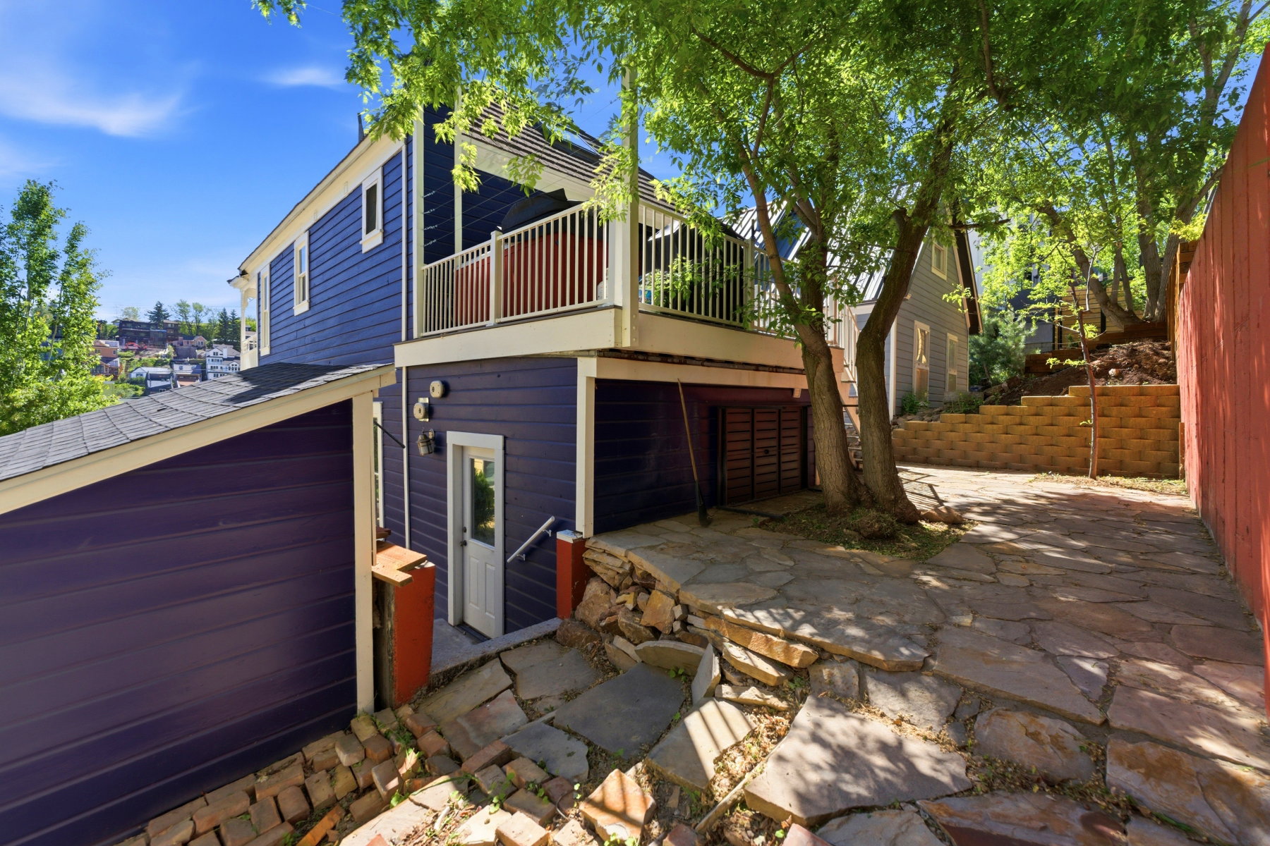 Multi-level residence featuring a vibrant blue exterior with white trim
