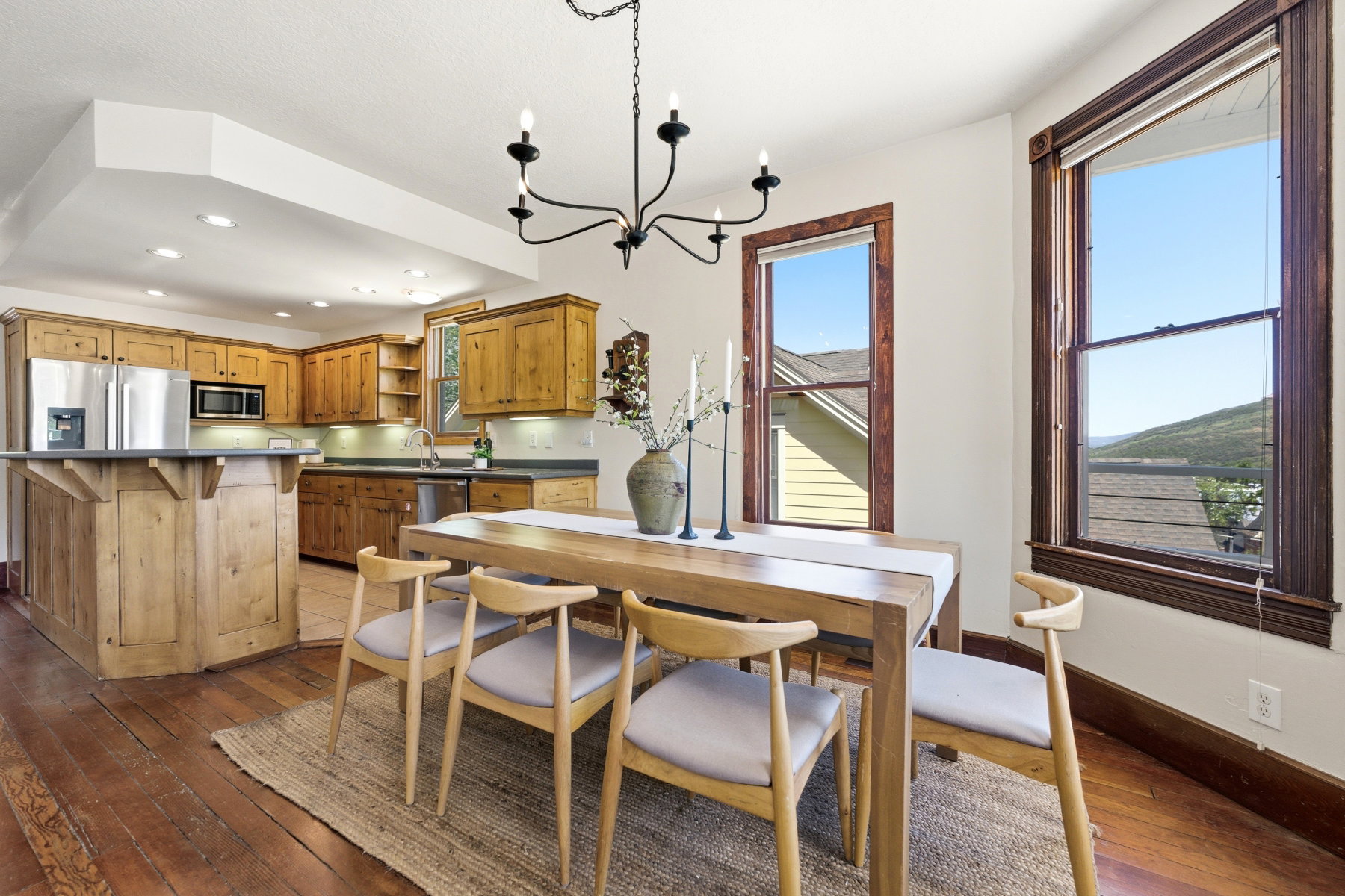 Open concept kitchen and dining area with wood-finish flooring