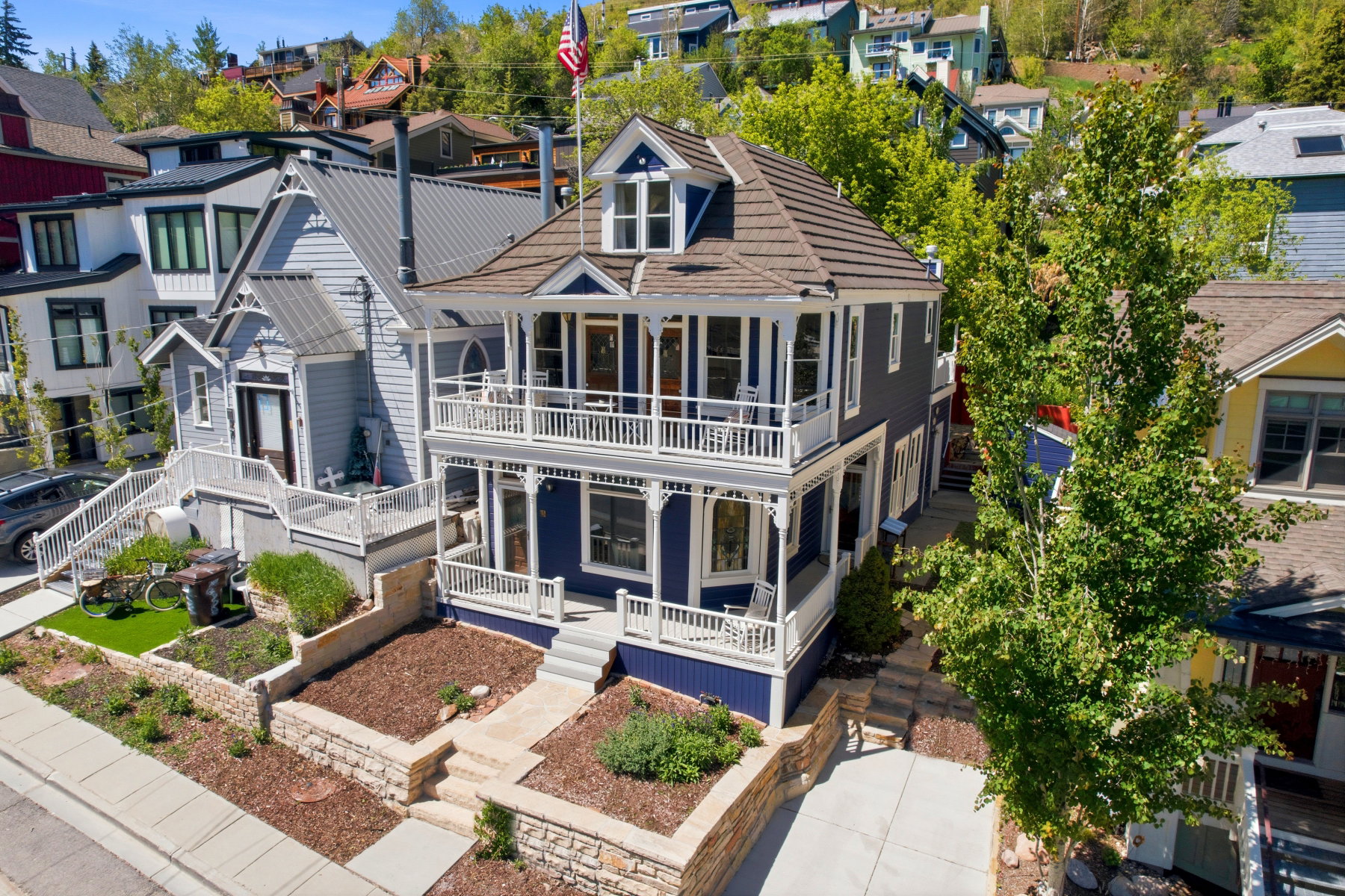 Two-story residence featuring a deep blue exterior, white trim, and a shingled roof