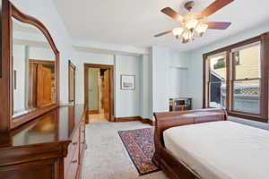 Bedroom featuring light colored carpet and a ceiling fan