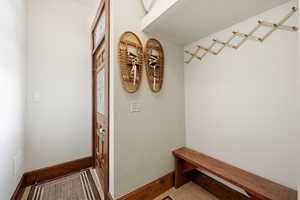 Mudroom with baseboards and tile patterned floors
