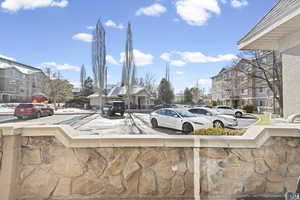 Covered patio off of family room with view of clubhouse