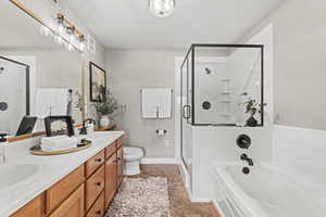 Primary Ensuite Bathroom with double vanity, a bathtub, and a stall shower
