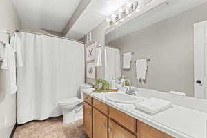 Bathroom featuring vanity and a shower with shower curtain