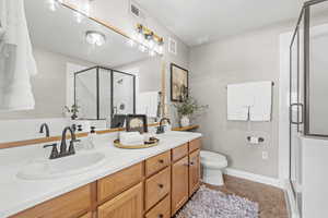 Primary Ensuite Bathroom with a shower stall, double vanity, and bathtub