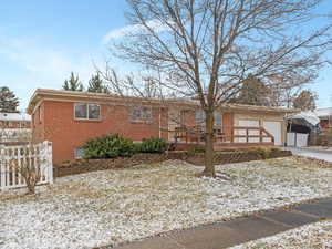 Ranch-style house with brick siding, a garage, and driveway