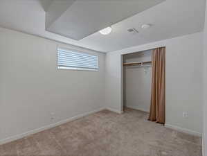 Unfurnished bedroom featuring a closet and light carpet