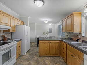 Kitchen with tasteful backsplash, a peninsula, white appliances, ornamental molding, and under cabinet range hood