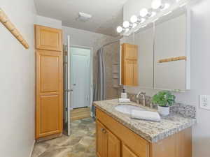 Bathroom with vanity and a shower with shower curtain