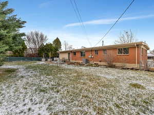 Rear view of property featuring brick siding and a patio area