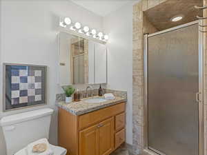 Bathroom featuring a stall shower and vanity