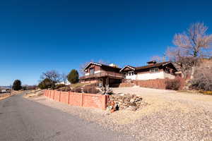 View of front of house with driveway and a chimney