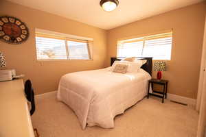 Bedroom with multiple windows and a textured ceiling