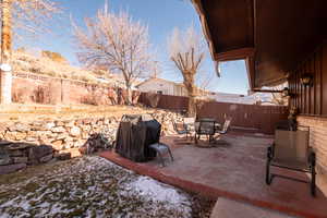 Fenced backyard featuring a patio, a grill, and outdoor dining area