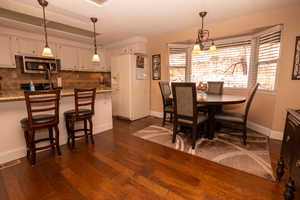 Dining room featuring a textured ceiling and dark wood finished floors