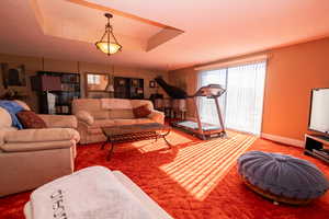 Living area with carpet floors and a textured ceiling