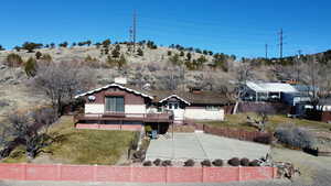 Rear view of house featuring a wooden deck and a fenced backyard