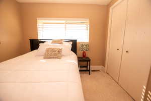 Bedroom featuring a closet and baseboards