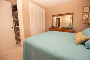 Bedroom featuring a textured ceiling and a closet