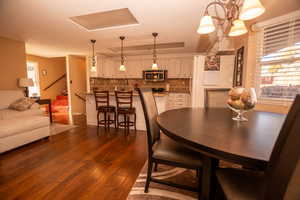 Dining space with dark wood finished floors and a textured ceiling