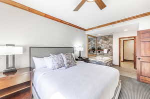 Bedroom with a ceiling fan, crown molding, and tile patterned flooring