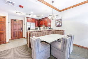 Dining area with recessed lighting, a chandelier, and light tile patterned flooring