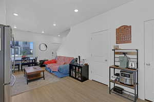 Living room featuring light wood-style flooring and recessed lighting