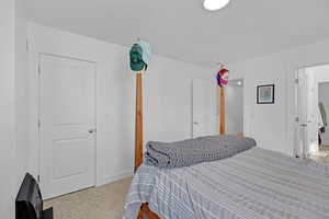 Carpeted bedroom featuring baseboards