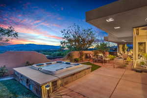 View of patio featuring a hot tub and a mountain view
