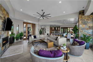 Tiled living room with a stone fireplace