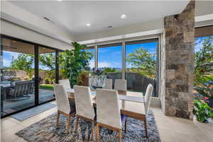 Dining space featuring light tile patterned floors
