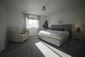 Primary bedroom with carpet flooring and baseboards