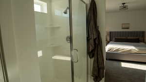 Ensuite bathroom featuring connected bathroom with a large shower with a glass door.