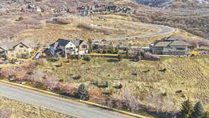 Aerial overview of property's location with nearby suburban area and a mountain backdrop