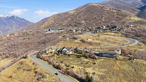 Aerial overview of property's location featuring nearby suburban area and mountains