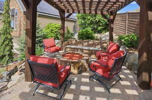 View of patio / terrace with a pergola and an outdoor fire pit