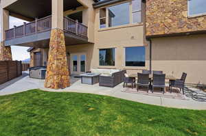 Patio / terrace featuring a hot tub, a patio area, and an outdoor living / dining area