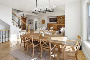 Dining area featuring stone tile flooring and a chandelier