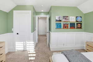 Bedroom with wainscoting, a decorative wall.