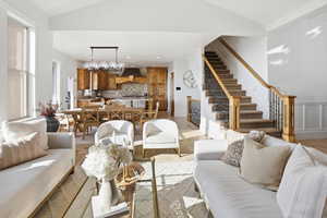 Living area with recessed lighting, light tile patterned floors, stairway, and lofted ceiling