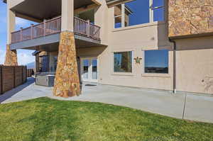 Rear view of property with a hot tub, stucco siding, french doors, and a fenced backyard