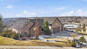View of front of house featuring stucco siding, stone siding, concrete driveway, and a garage