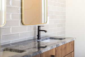 Bathroom view of decorative backsplash and vanity