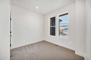 Unfurnished room with carpet floors and recessed lighting