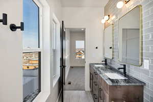 Bathroom with double vanity and light carpet